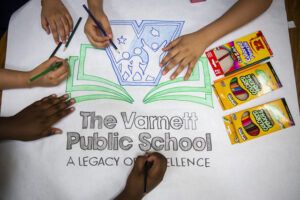 children's hands drawing Varnett Public School logo
