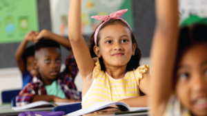 students with hands raised