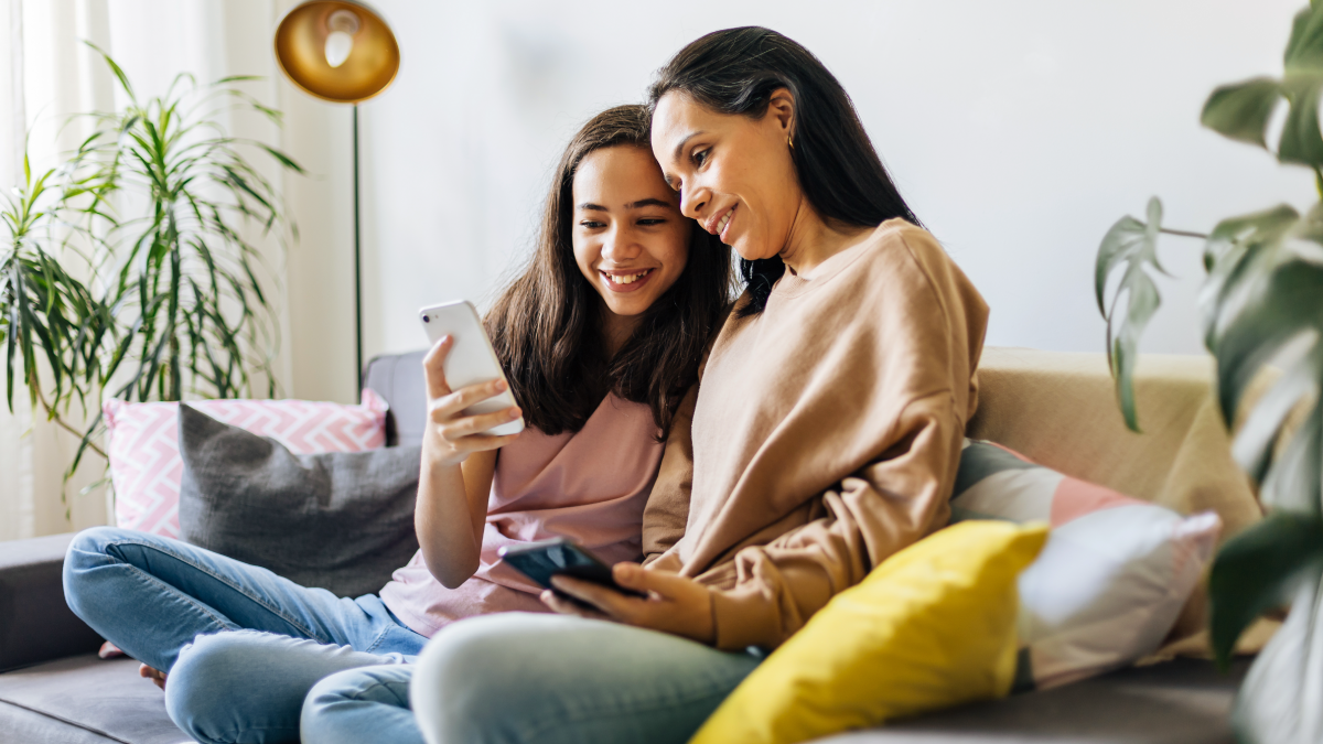 mother and daughter looking at phone