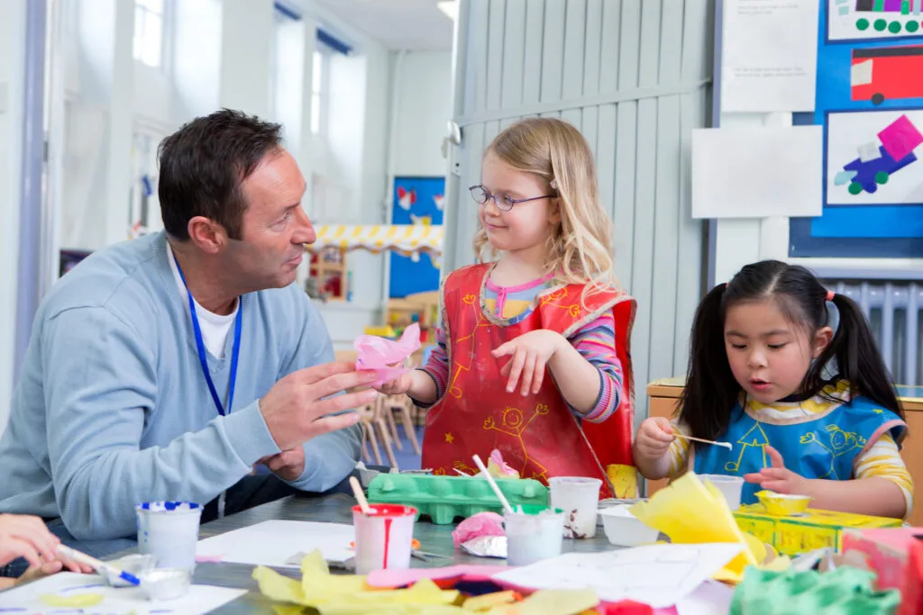Teacher talking to students in art classroom