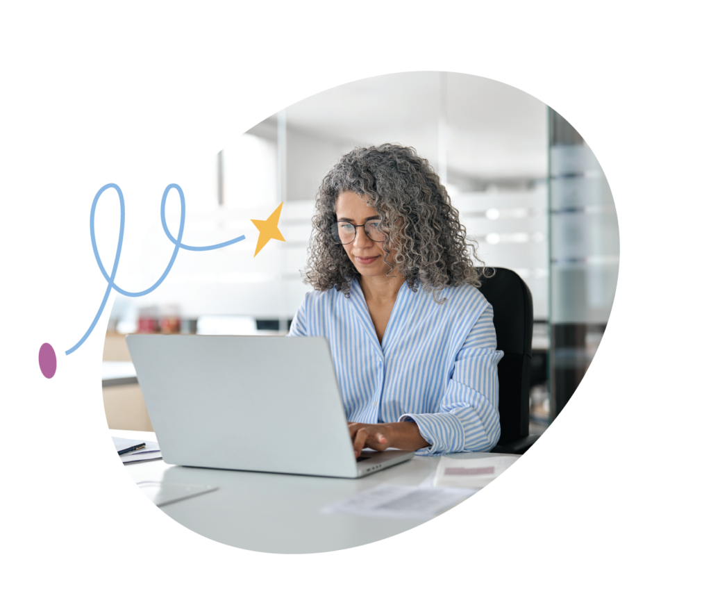 woman in office typing on laptop