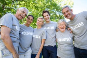 happy group of volunteers posing outside