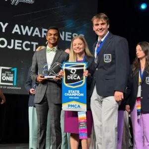 students accepting award at podium