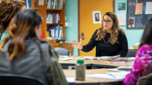 A principal leading a discussion with a group of teachers during a faculty meeting.