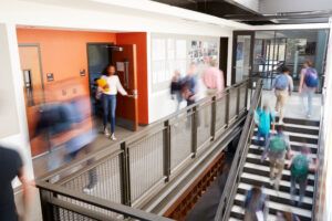 school hallways with staff and students in blurred motion