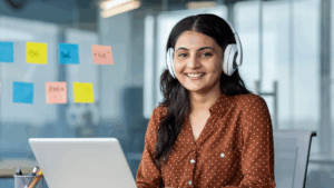smiling laptop user with headphones