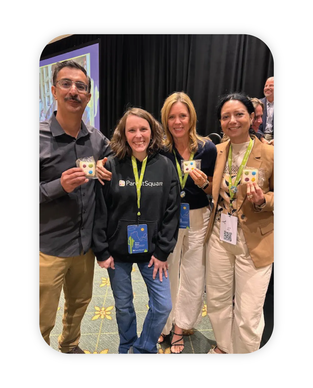 ParentSquare founders posing with ParentSquare cookies at company event