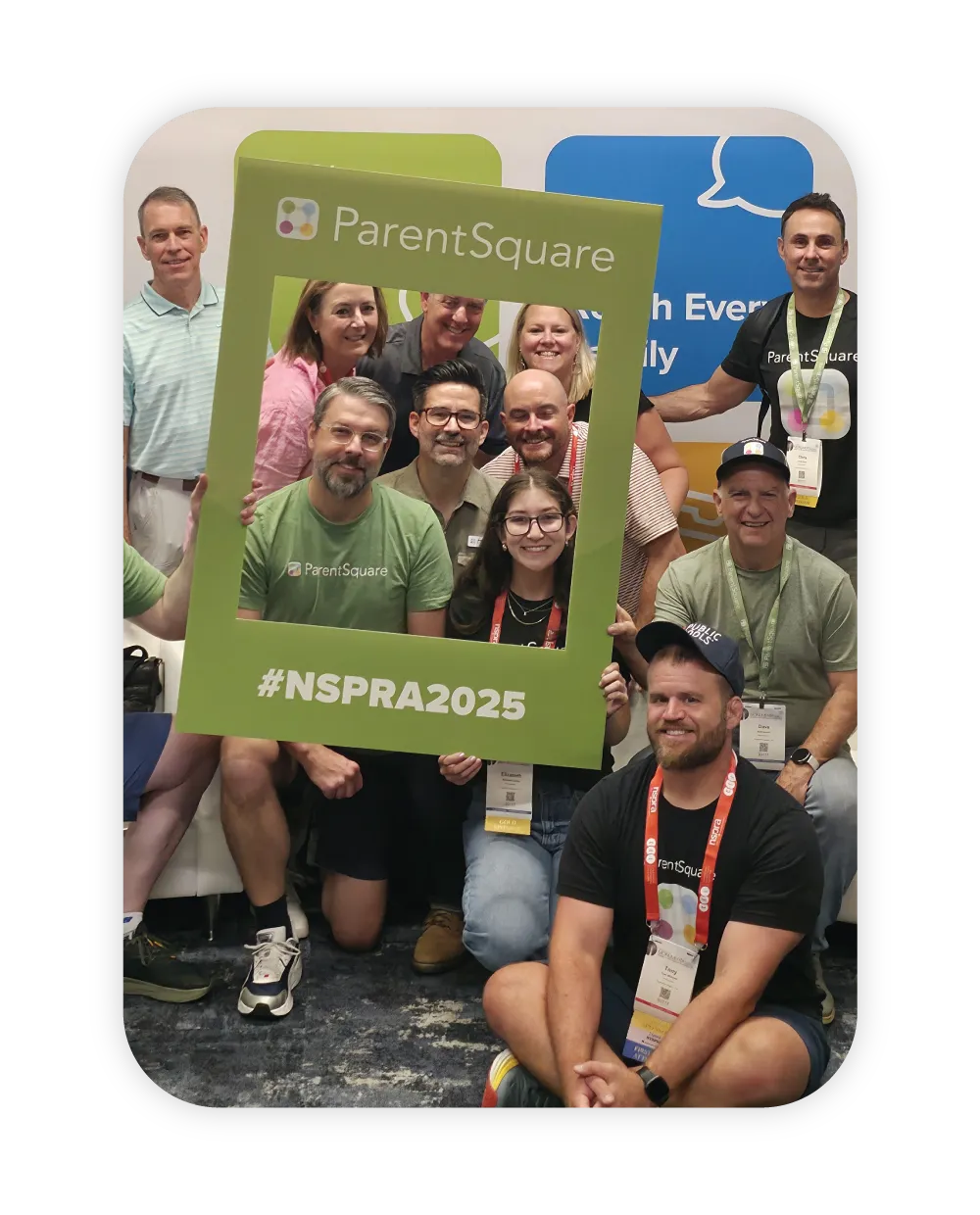 group of ParentSquare employees posing with photo frame at conference