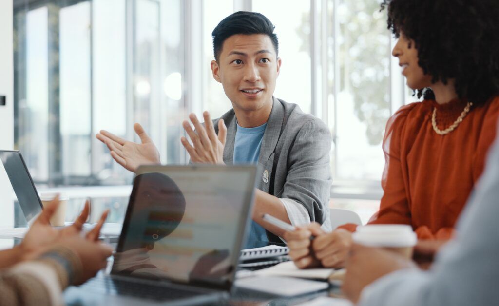 team collaborating in discussion at conference table