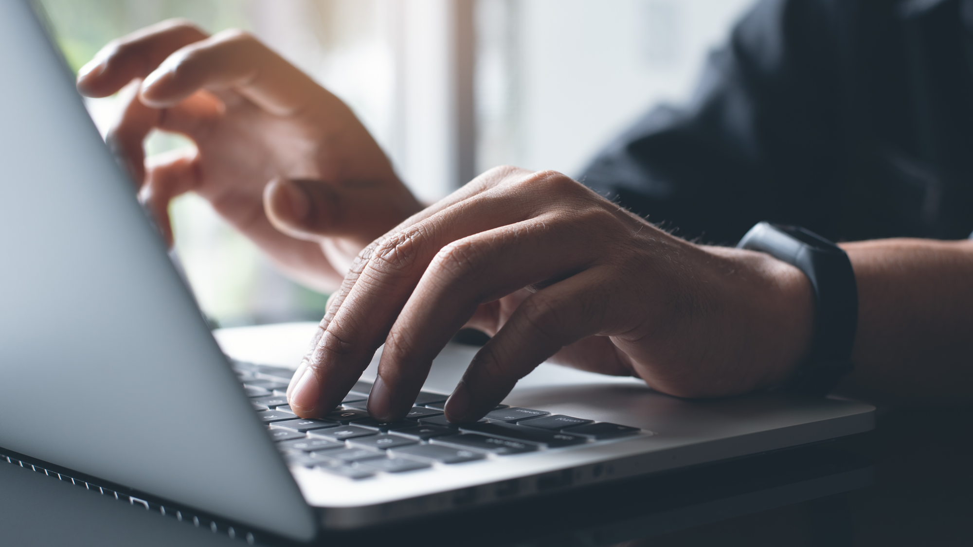 hands typing on keyboard