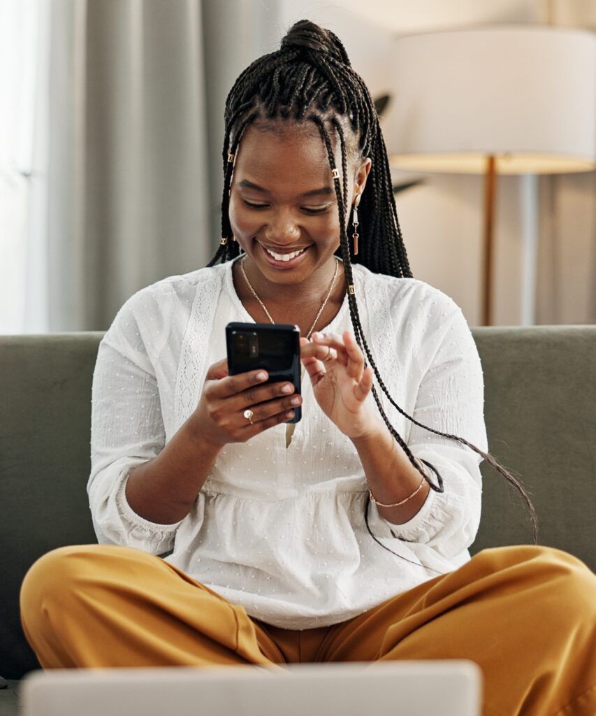 Happy woman making payment on phone