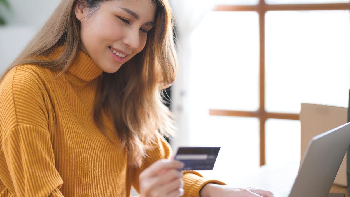 woman making payment with credit card at laptop