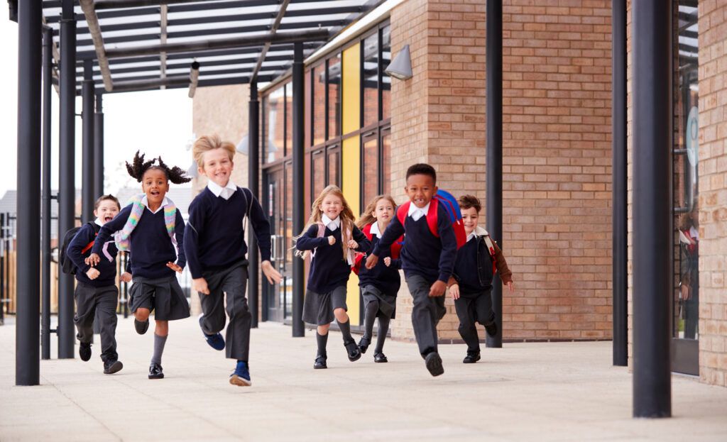 Elementary students enjoying campus life at a private school, showcasing a vibrant school community and positive student experience.