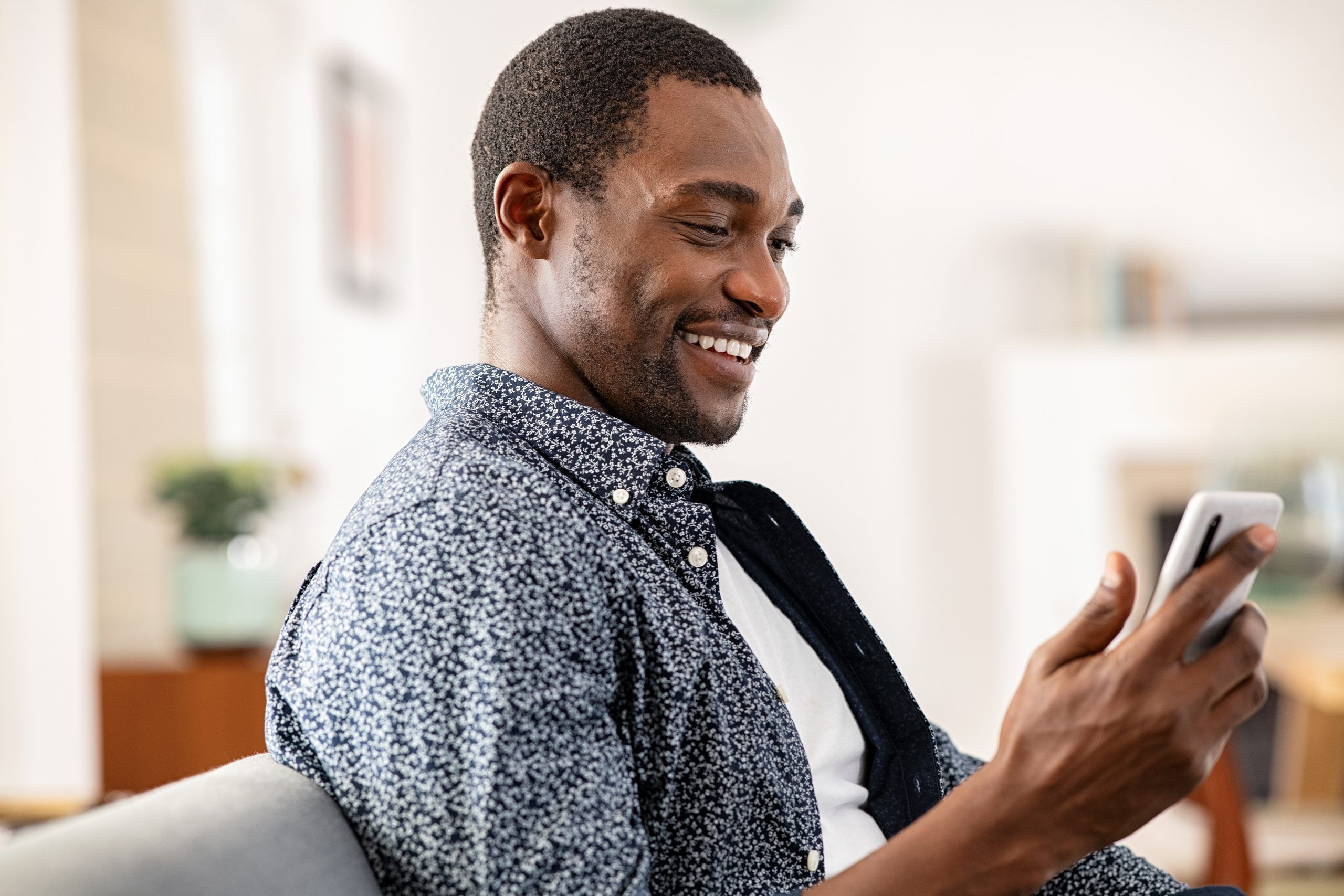 A father checking his phone for school communications for his child