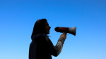 silhouette of woman with megaphone